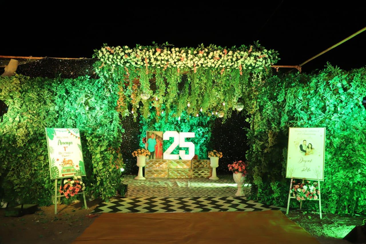 A romantic candlelit setup with warm golden hues, heart-shaped decor, and a charming black-and-yellow theme. The cozy outdoor ambiance, surrounded by lush greenery, makes it a perfect setting for a special evening.